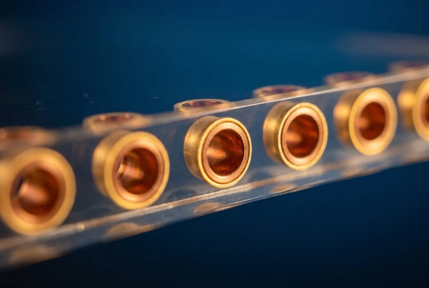 Edge view of copper-filled through-glass vias with isolation liner in a glass wafer